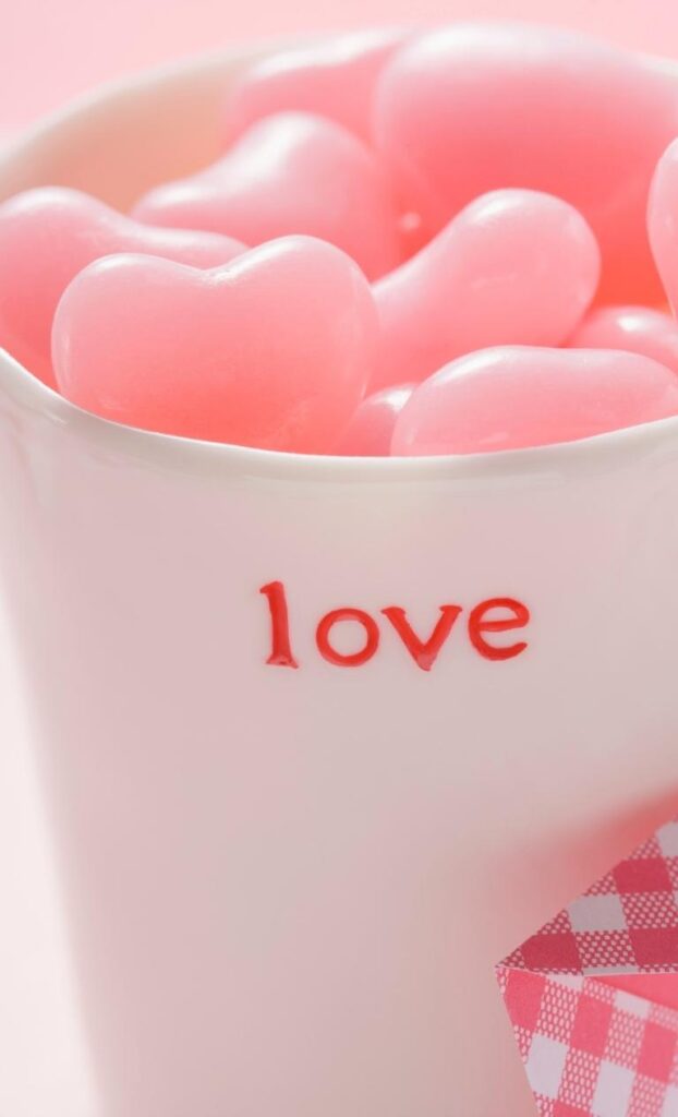 Cutest Valentines iPhone wallpaper showcasing candy motifs